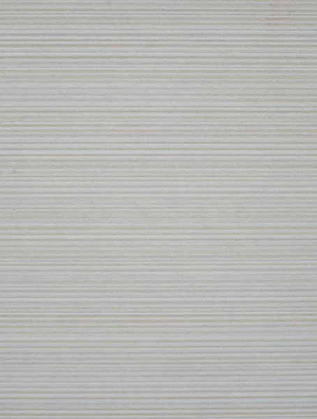 Ecru keramiska plattor med horisontella linjer på väggen — Stockfoto
