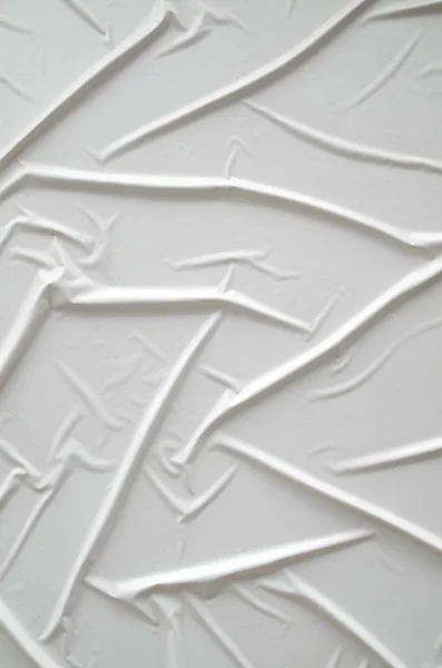 Decorative plaster imitating glued white paper on wall — Stock Photo, Image