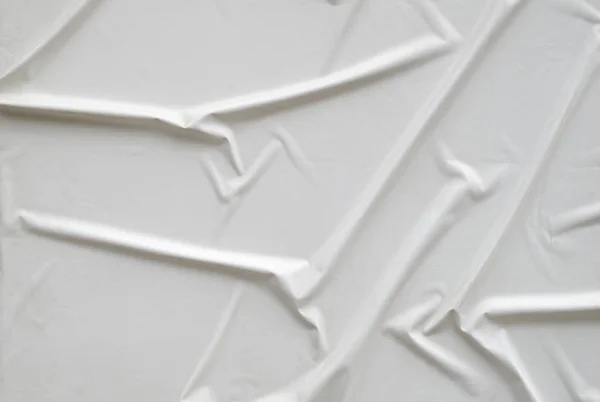 Decorative plaster imitating glued white paper on wall — Stock Photo, Image