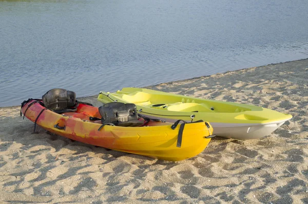 Dos tipos de kayak de dos asientos sentarse en la parte superior en la orilla arenosa de la — Foto de Stock