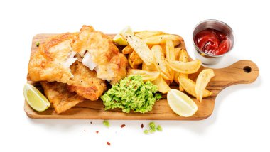 British Traditional Fish and chips with mashed peas and sauce isolated on white background clipart