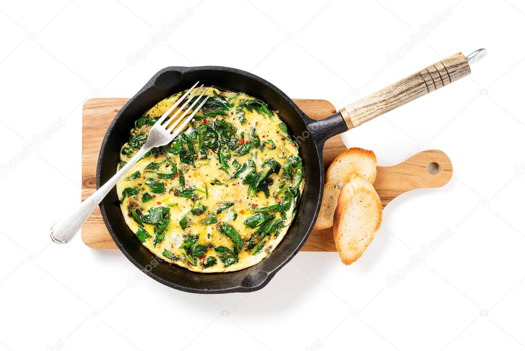 Omelette with baby spinach in cast iron pan, healthy breakfast . isolated on white background.