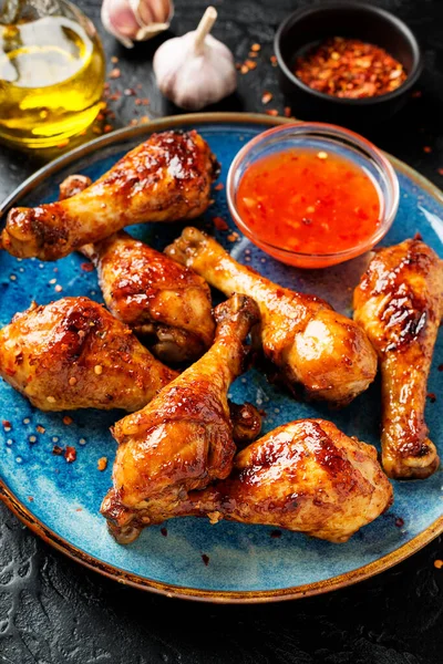 Roasted spicy chicken legs with chili sauce.