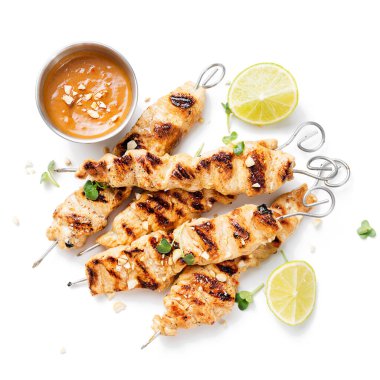 Grilled chicken satay skewers with peanut butter sauce. isolated on white background clipart