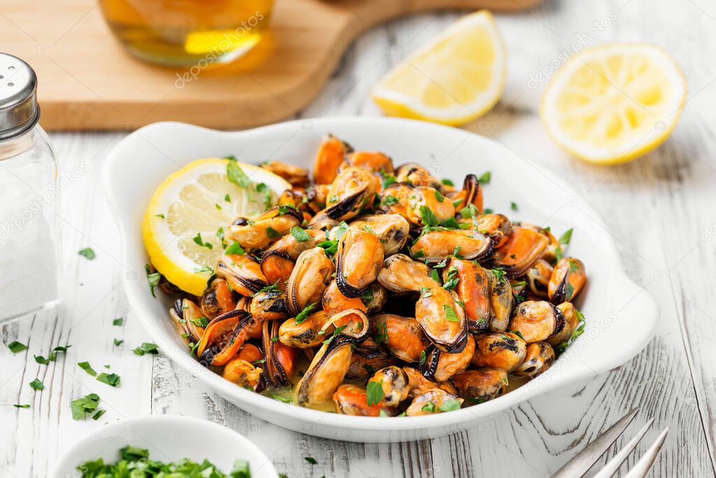 Delicious seafood mussels with lemon and parsley.