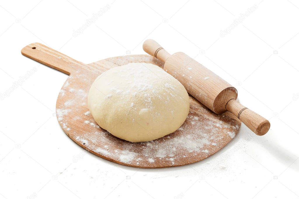 Fresh raw dough for pizza or bread baking on wooden cutting board isolated on white background. 