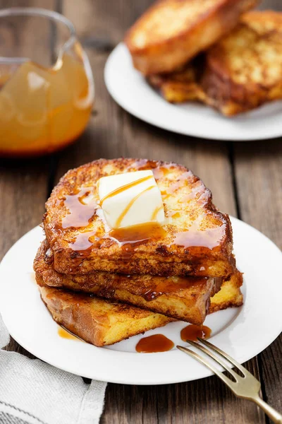 French toasts with butter and caramel sauce for breakfast.