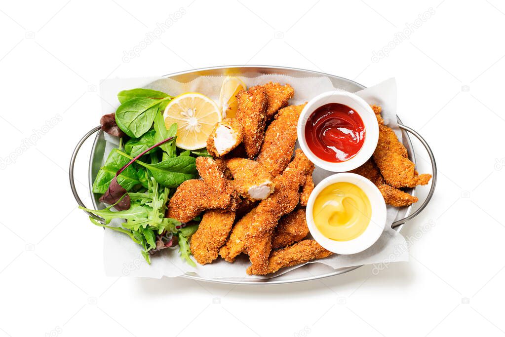 Delicious crispy fried breaded chicken breast strips with green salad and different sauces. isolated on white background
