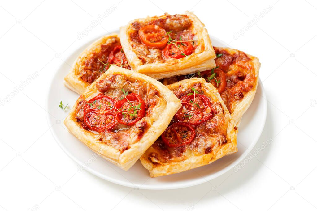 Puff pastry mini pies with cheese and tomatoes isolated on white background