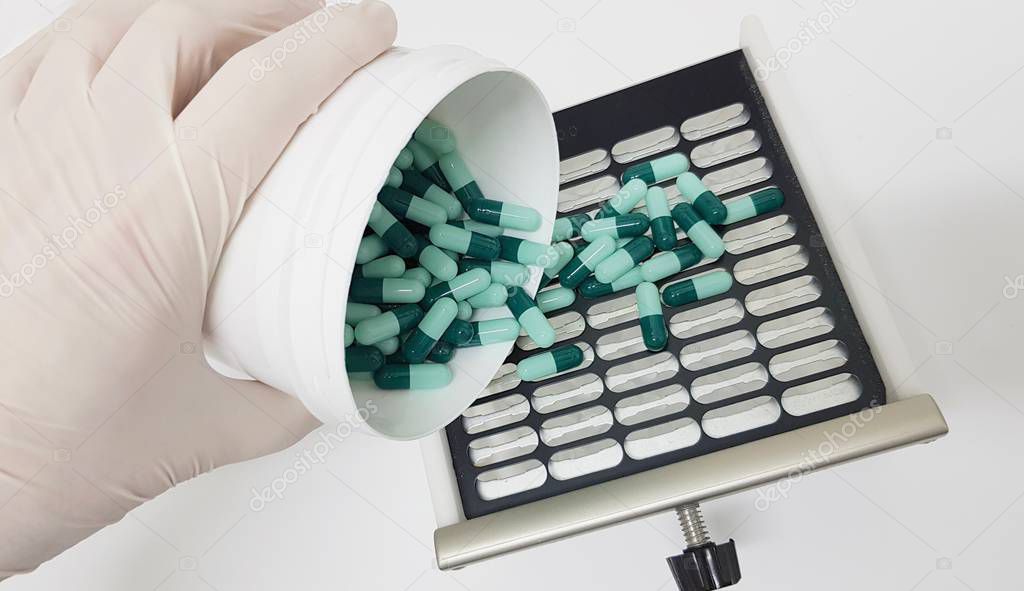 Preparing a prescription in capsules using a manual machine to make capsules 