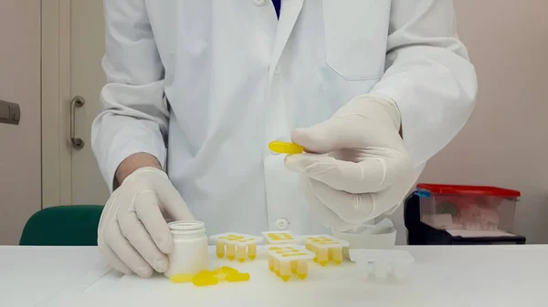 Pharmaceutical making yellow suppositories — Stock Photo, Image