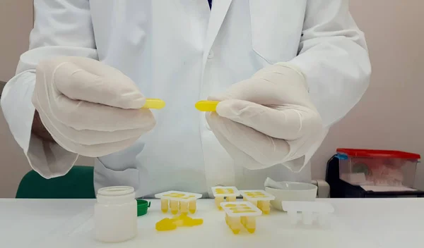 Pharmaceutical making yellow suppositories — Stock Photo, Image