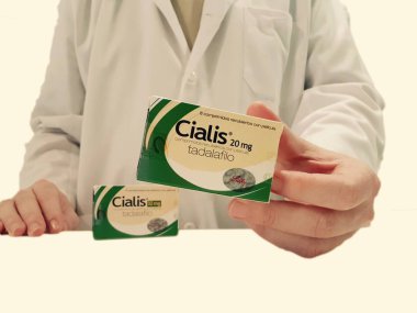 Pharmacist showing a box of Cialis  clipart