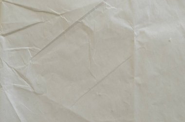 Kırışmış beyaz kağıdın dağınık kaplamasına sahip yaratıcı bir zemin.