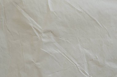 Kırışmış beyaz kağıdın dağınık kaplamasına sahip yaratıcı bir zemin.