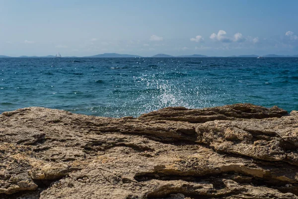 Wellen brechen an einem steinigen Strand in Murter, Kroatien, Dalmatien — Stockfoto