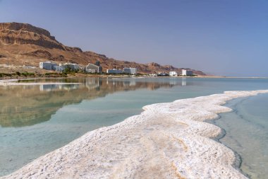 Ein Bokek Hotels against the backdrop of mountains and sky from the salt formations of the Dead Sea