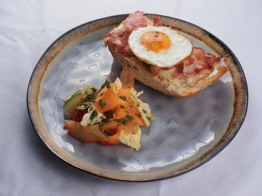 Kızarmış yumurta, pastırma, peynir ve sebzeli sandviç..