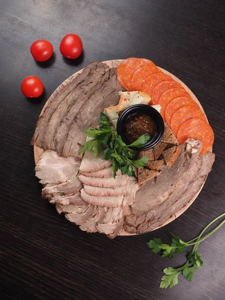 Food tray with slices of meat, bread, delicious salami - cold cuts with a choice