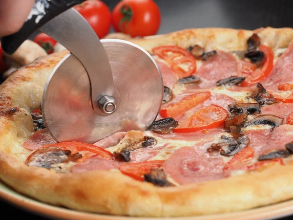 Cutting slice of pizza close up Royalty Free Stock Images