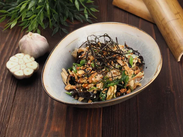 Bowl of Korean Salad with Asparagus, Radish, Kinza and Nut Sauce on a Wooden Table. Close up. Food photography for menu — Stock Image Bowl Korean Salad Asparagus Radish Kinza Nut Sauce Wooden Table Royalty Free Stock Photos