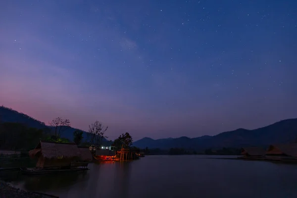 Bamboo houses with mountain on the calm lake backgroud in the morning at Khao wong reservoir, Suphanburi province, Thailand