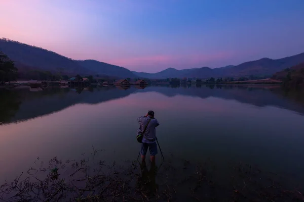 Bamboo houses with mountain on the calm lake backgroud in the morning at Khao wong reservoir, Suphanburi province, Thailand