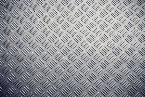Seamless metal floor plate with diamond pattern.