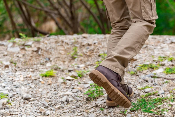 Man wearing cargo pants and climbing on the rock