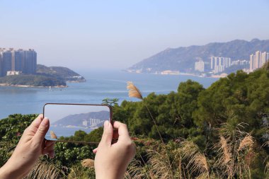 Hong Kong cep telefonuyla kıyı peyzaj Turizm alarak resmi