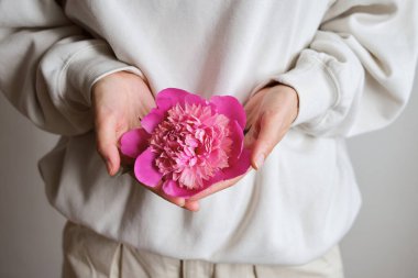 Mutlu bir kadının ellerinde şakayık çiçeği. Şakayık Bud ve taç yaprakları yakın plan. Güzel bir bahar buketi. Çiçekli çiçekçi kız. Taze çiçek. Sevdiğin birinden romantik bir sürpriz.