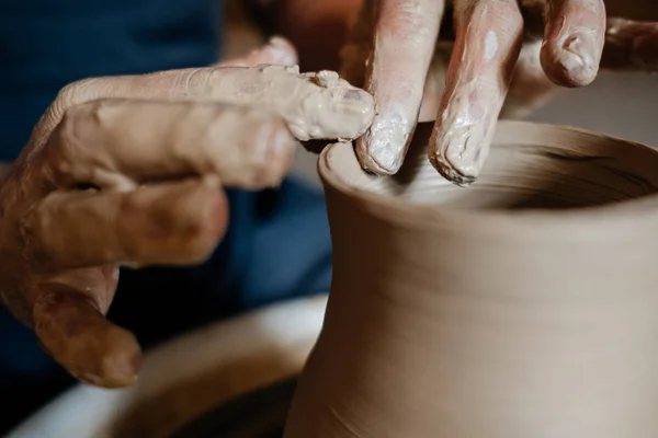 Creation of a vase and modeling of clay in a professional pottery workshop