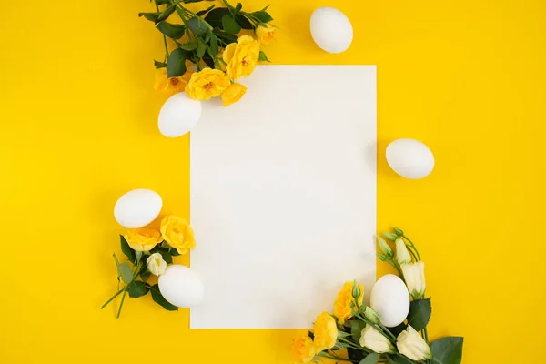 Empty card with easter decorations on yellow background with copy spac