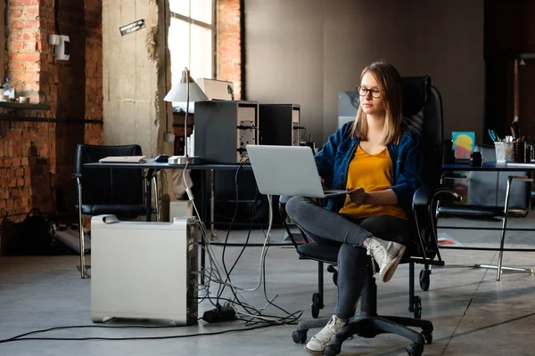 A girl works at a computer in a modern office