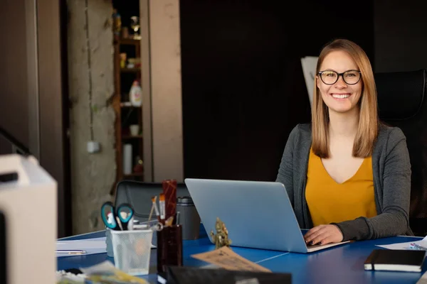 A girl works at a computer in a modern office