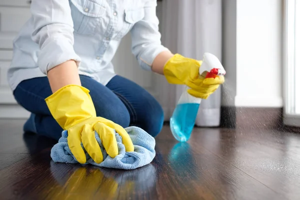 The girl washes the floor at home