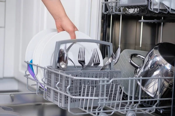 The girl collects disassembled dishwasher