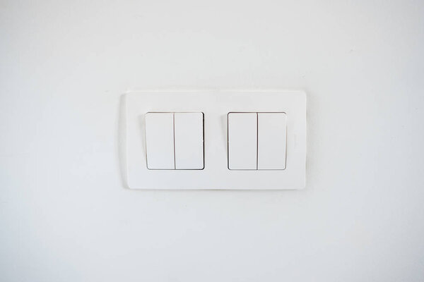 White light switches on the white wall