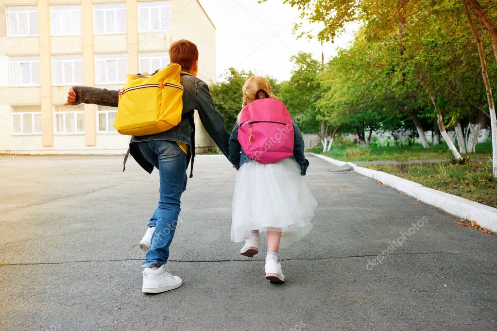 Boy with girl hold hand run to school