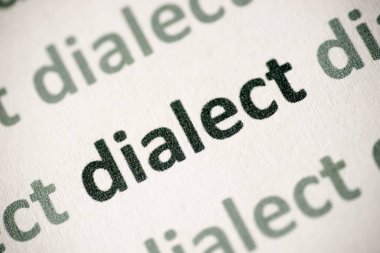 word dialect printed on white paper macro clipart