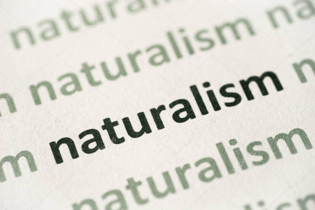 word naturalism printed on white paper macro