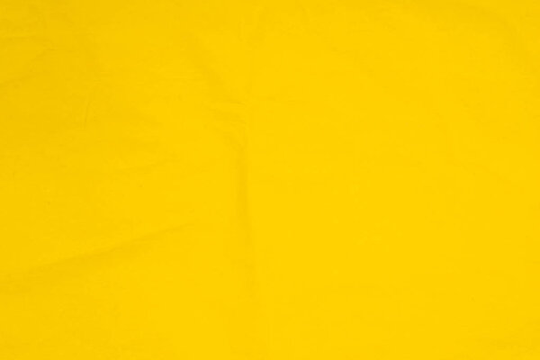 Желтый цвет складки ткани текстуры фона бумаги
