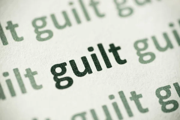 Word Guilt Printed White Paper Macro — Stock Photo, Image