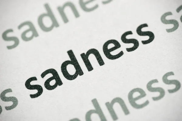 Word Sadness Printed White Paper Macro — Stock Photo, Image