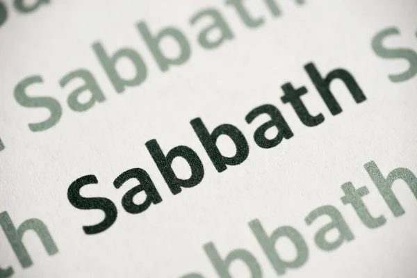 word Sabbath printed on white paper macro