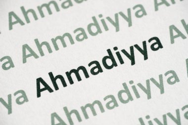 word Ahmadiyya printed on white paper macro clipart