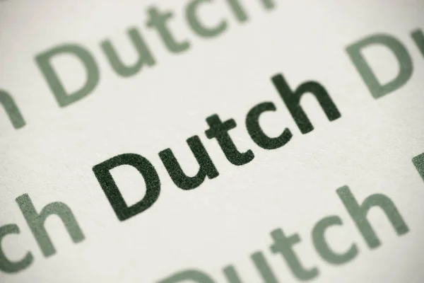 Palavra Língua Holandesa Impressa Papel Branco Macro — Fotografia de Stock