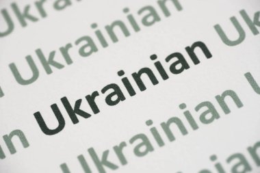 word Ukrainian language printed on white paper macro clipart