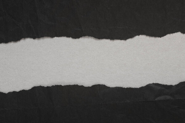 black torn paper with copy space on gray background texture