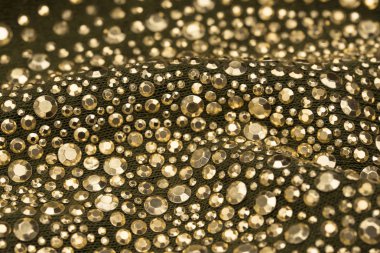 doku Tekstil seçici odak üzerinde altın pullu 